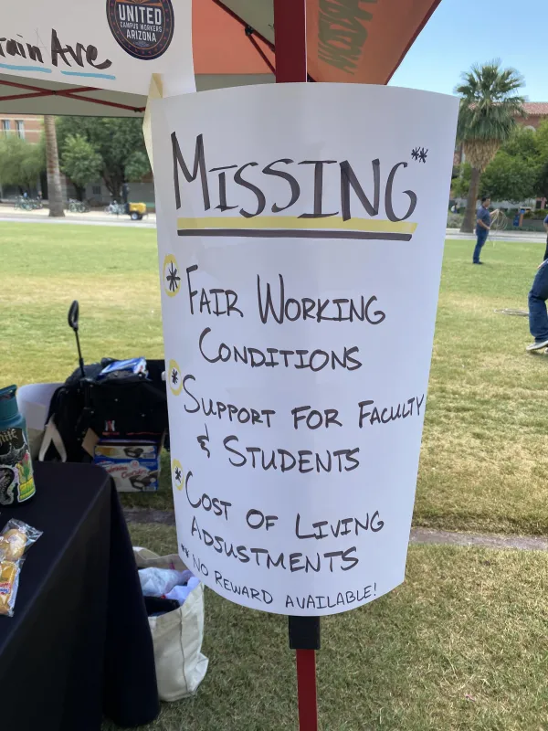 Picture is of a sign that says "MISSING: Fair working conditions, support for faculty and students, cost of living increases"